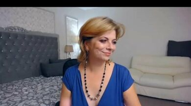 Sexy mature cam model dances in blue dress before smoking and dildo play