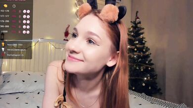 Cute teen camgirl wearing furry lingerie poses on bed